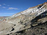 Tibet Kailash 06 Tirthapuri 13 Pilghrim Walking Below Topa Moro Red and White Terraces